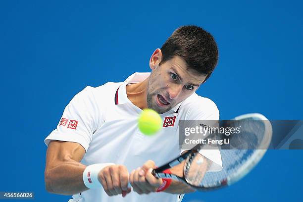 Novak Djokovic of Serbia returns a shot against Grigor Dimitrov of Bulgaria during day seven of the China Open at the National Tennis Center on...