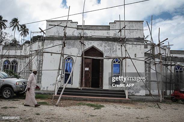 Moderate muslim cleric Sheikh Fadhil Soraga, who was injured in an acid attack last year, walks in Zanzibar on November 17, 2013. This popular...