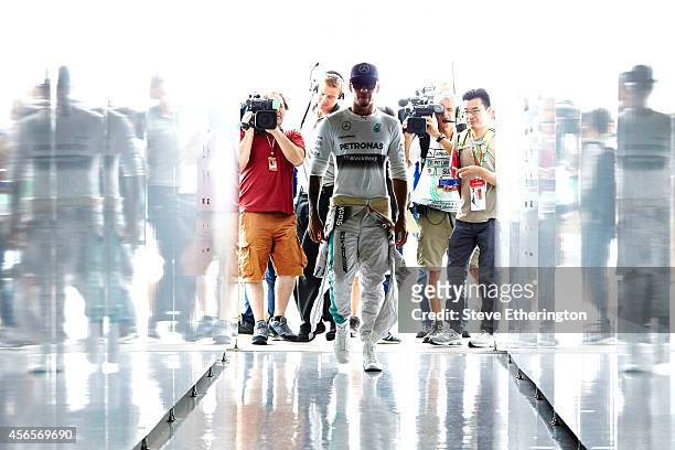 Lewis Hamilton of Great Britain and Mercedes GP walks into the team garage during practice for the Japanese Formula One Grand Prix at Suzuka Circuit...