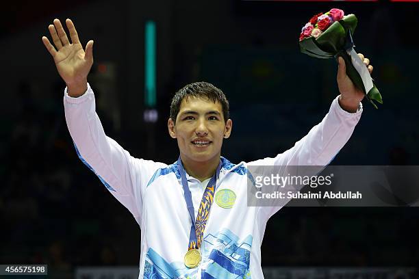 Zhanibek Alimkhanuly of Kazakhstan celebrates winning gold after defeating Odai Riyad Adel Alhindawi of Jordan during the Men's Middle Weight Final...