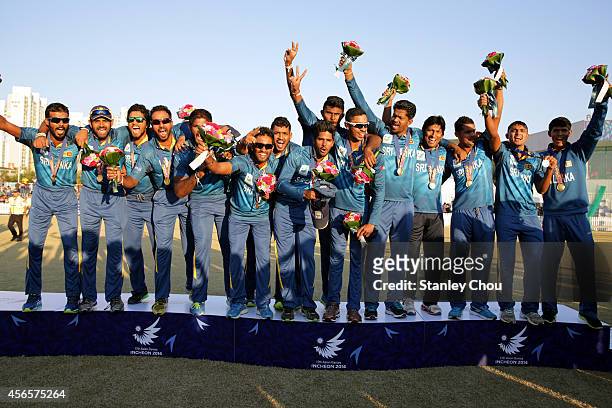 Sri Lanka players celebrate with their Gold Medals during the victory ceremony after the Mens Cricket Gold Medal match between Afganistan and Seri...