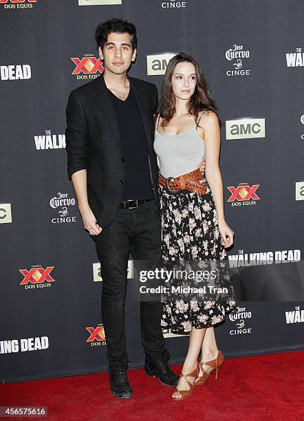 Nick Simmons and actress Alex Essoe arrive at AMC's "The Walking Dead" Season 5 Premiere held at AMC Universal City Walk on October 2, 2014 in...