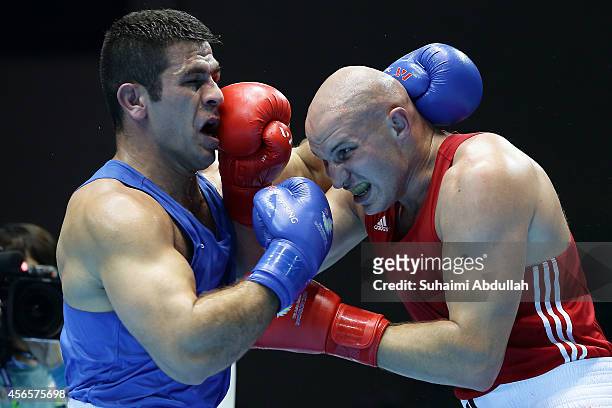 Ivan Dychko of Kazakhstan fights Jasem Delavari of Iran during the Men's Super Heavyweight Final on day fourteen of the 2014 Asian Games match at...