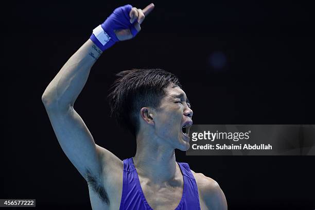 Shin Jonghun of South Korea reacts after defeating Birzhan Zhakypov of Kazakhstan during the Men's Light Flyweight final on day fourteen of the 2014...
