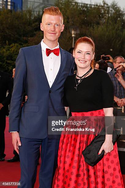 Tobias Staerbo and Enie van de Meiklokjes attend the red carpet of the Deutscher Fernsehpreis 2014 on October 02, 2014 in Cologne, Germany.