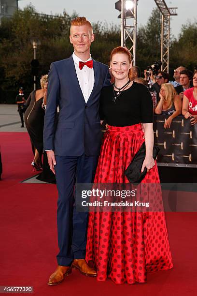 Tobias Staerbo and Enie van de Meiklokjes attend the red carpet of the Deutscher Fernsehpreis 2014 on October 02, 2014 in Cologne, Germany.