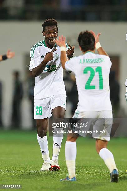 Kouko Guehi of Raja Casablanca is congratulated by Adil Karrouchy after winning 2-1 during the FIFA Club World Cup Quarter Final match between Raja...