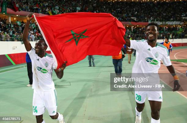 Vivien Mabide and Kouko Guehi of Raja Casablanca celebrate victory over CF Monterrey after the FIFA Club World Cup Quarter Final match between Raja...