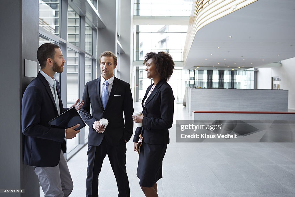 Business people having casual meeting in hall