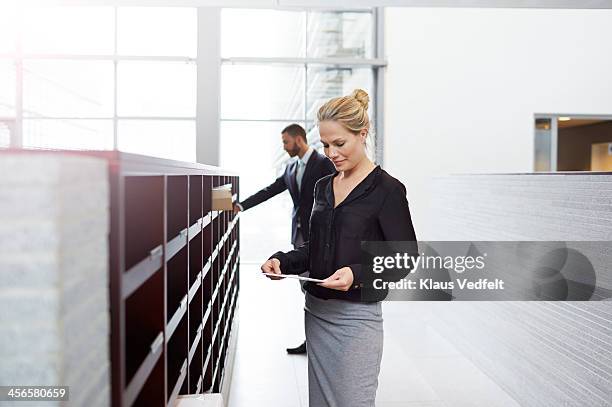 businesswoman picking up letter from dovecote - picking up mail stock pictures, royalty-free photos & images