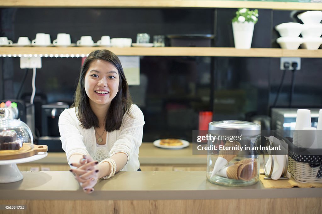 Young woman working in cafe.
