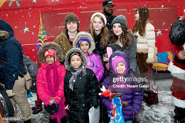 Brenden Meyer, Kerris Dorsey and Juliette Goglia pose with kids at the 2013 CitySightseeing New York holiday toy drive at PAL's Harlem Center on...