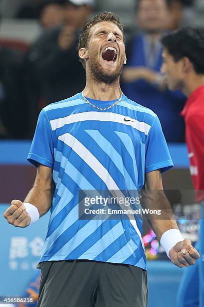 Martin Klizan of Slovakia celebrates winning against Rafael Nadal of Spain during day seven of the China Open at the China National Tennis Center on...