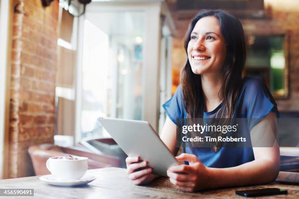 woman using digital tablet in cafe. - coffee table stock photos et images de collection
