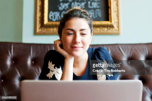 Woman looking at screen in cafe.