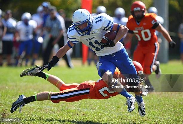 Scituate High School's Fran Donovan is tripped up by Middleboro's Paul Sances during game action.