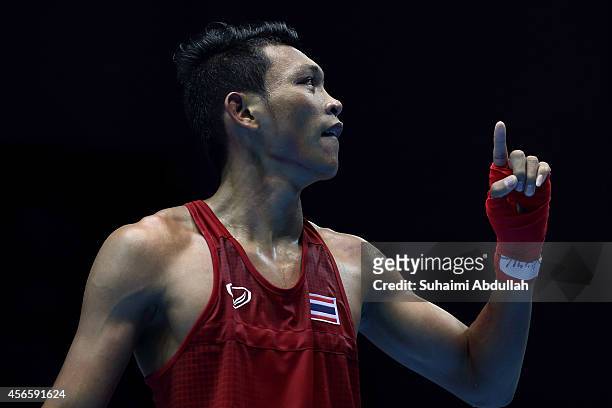 Wuttichai Masuk of Thailand reacts at the end of his fight with Lim Hyunchul of South Korea during the men's boxing light welter weight bout final on...