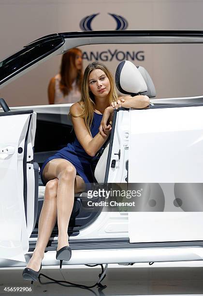 Model poses next a Ssangyong during the second press day of the Paris Motor Show on October 03 in Paris, France. The Paris Motor Show will showcase...