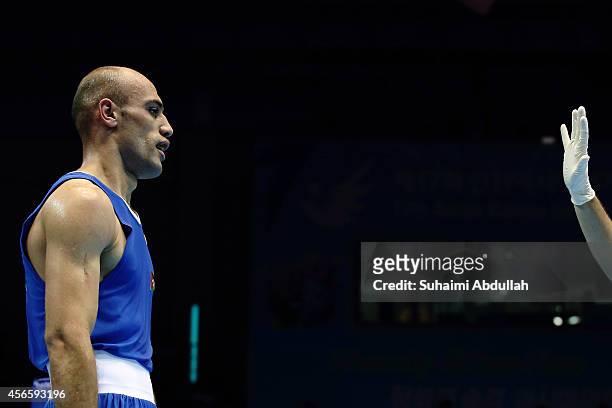 Odai Riyad Adel Alhindawi of Jordan gets a standing eight count from the referee during his fight with Zhanibek Alimkhanuly of Kazakhstan during the...