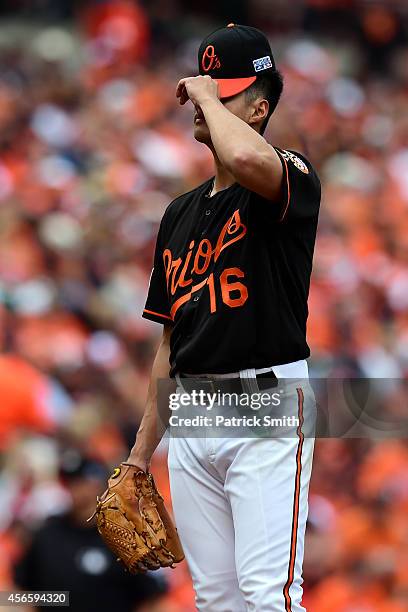 Wei-Yin Chen of the Baltimore Orioles reacts after J.D. Martinez of the Detroit Tigers hit a three run home run scoring Miguel Cabrera and Victor...
