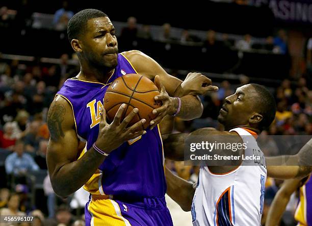 Ben Gordon of the Charlotte Bobcats tries to steal the ball from Shawne Williams of the Los Angeles Lakers during their game at Time Warner Cable...