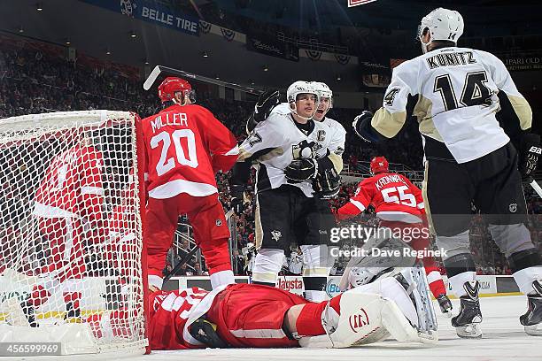 Goalie Jonas Gustavsson of the Detroit Red Wings lays on the ice as Sidney Crosby, Evgeni Malkin and Chris Kunitz of the Pittsburgh Penguins...