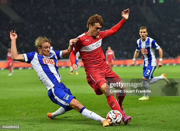 Per Ciljan Skjebred of Berlin is challenged by Gotoku Sakai of Stuttgart during the Bundesliga match between Hertha BSC and Vfb Stuttgart at...