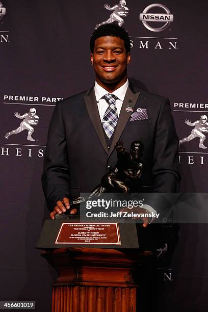 Jameis Winston, quarterback of the Florida State Seminoles, poses with the trophy during a press conference after the 2013 Heisman Trophy...