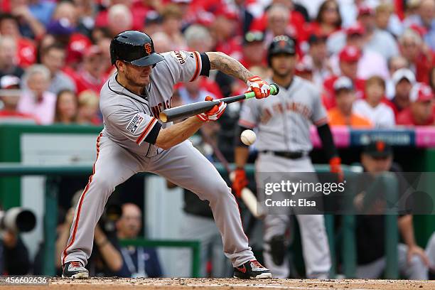 Jake Peavy of the San Francisco Giants bunts in the third inning against the Washington Nationals during Game One of the National League Division...