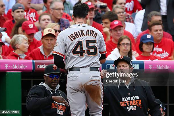 Travis Ishikawa of the San Francisco Giants is welcomed to the dugout after scoring on a single by Joe Panik in the third inning against the...