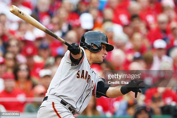 Joe Panik of the San Francisco Giants hits an RBI single scoring Travis Ishikawa in the third inning against the Washington Nationals during Game One...
