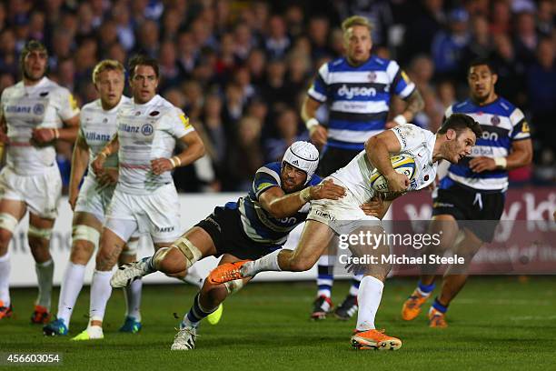 Dave Attwood of Bath holds onto Duncan Taylor of Saracens during the Aviva Premiership match between Bath Rugby and Saracens at the Recreation Ground...