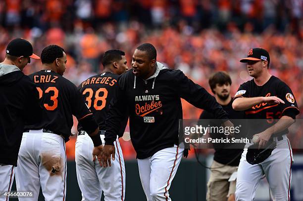 Delmon Young of the Baltimore Orioles celebrates with teammate Nelson Cruz after defeating the Detroit Tigers 7 - 6 in Game Two of the American...