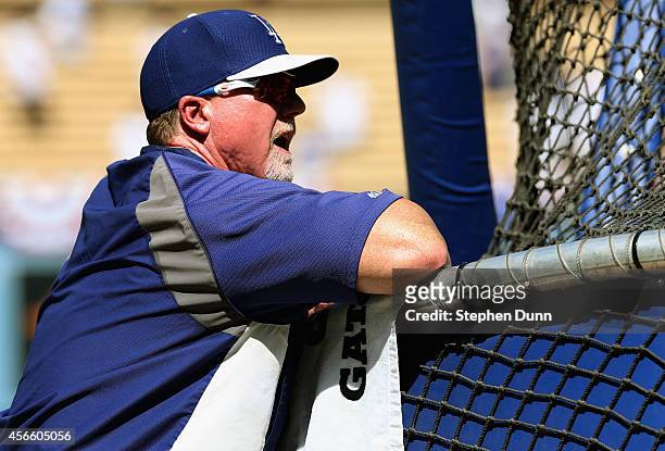 Batting coach Mark McGwire of the Los Angeles Dodgers watches batting practice before Game One of the National League Division Series against the St....