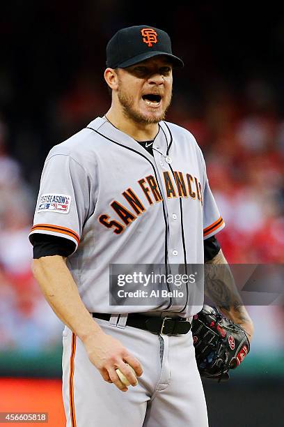 Jake Peavy of the San Francisco Giants reacts after walking Jayson Werth of the Washington Nationals in the sixth inning during Game One of the...