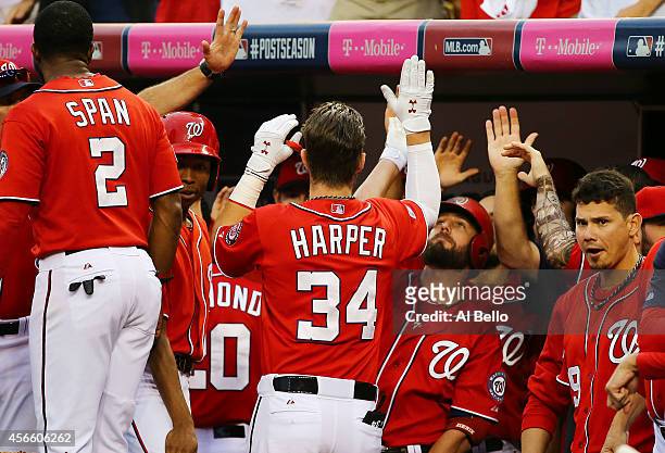 Bryce Harper of the Washington Nationals celebrates his home run with teammates in the seventh inning against the San Francisco Giants during Game...