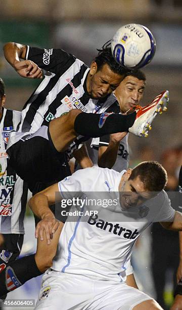 Heredia's Osmar Lopez vies for the ball with Comunicacione's Mynor Lopez during the 2013 Aperture Tournament final football match at Cementos...