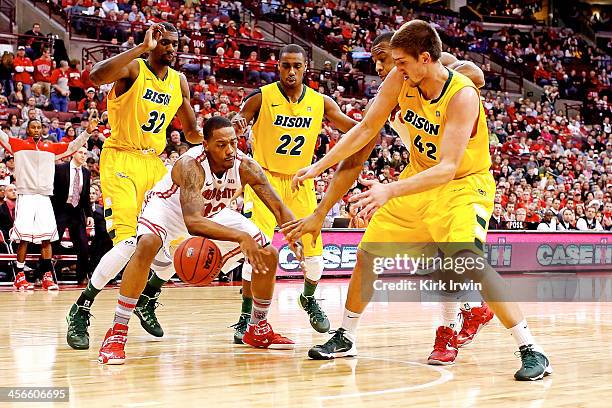 Lenzelle Smith, Jr. #32 of the Ohio State Buckeyes attempts to keep the ball from Marshall Bjorklundj, Kory Brown, and TrayVonn Wright, all of the...