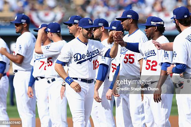Andre Ethier of the Los Angeles Dodgers high fives teammates before playing in Game One of the National League Division Series against the St. Louis...