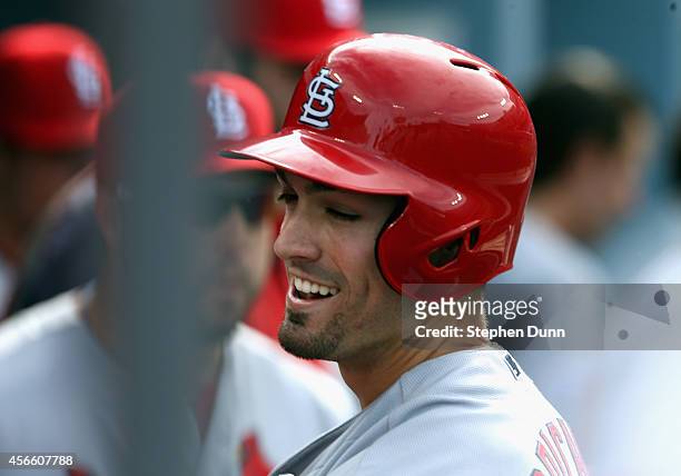Randal Grichuk of the St. Louis Cardinals smiles in the dugout after hitting a homerun to score in the first inning of Game One of the National...