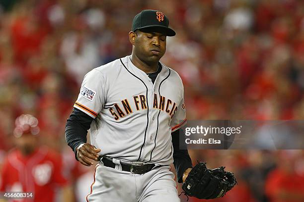 Santiago Casilla of the San Francisco Giants reacts in the ninth inning against the Washington Nationals during Game One of the National League...