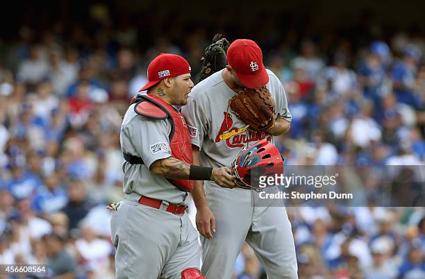 Starting pitcher Adam Wainwright of the St. Louis Cardinals and catcher Yadier Molina talk during the second inning against the Los Angeles Dodgers...