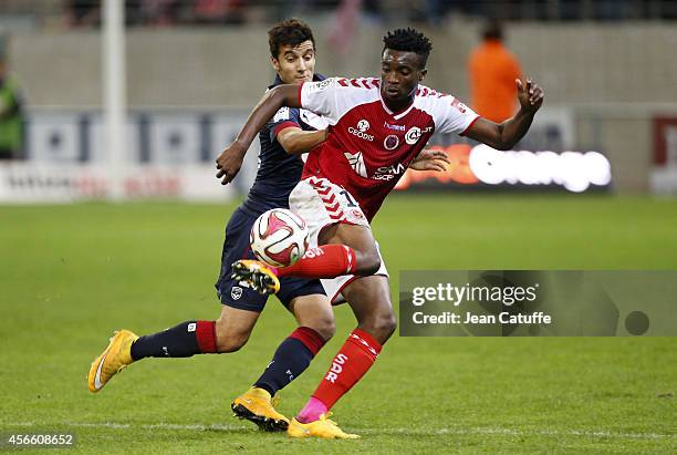 Benjamin Moukandjo of Stade de Reims and Younes Kaabouni of Bordeaux in action during the French Ligue 1 match between Stade de Reims and FC...