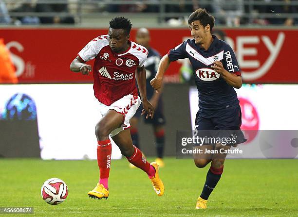 Benjamin Moukandjo of Stade de Reims and Younes Kaabouni of Bordeaux in action during the French Ligue 1 match between Stade de Reims and FC...