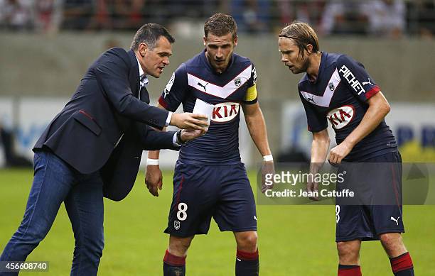 Head coach of Bordeaux Willy Sagnol talks to Gregory Sertic and Jaroslav Plasil of Bordeaux during the French Ligue 1 match between Stade de Reims...
