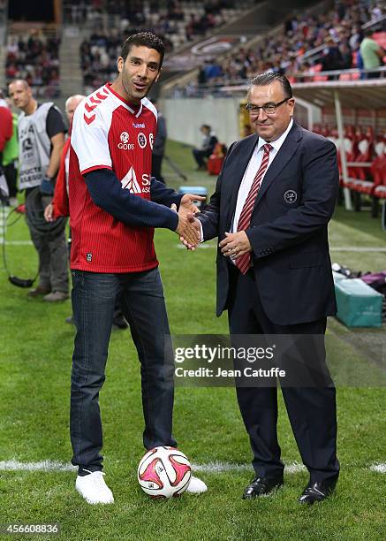 Track and field champion born in Reims Mahiedine Mekhissi - here with president of Stade de Reims Jean-Pierre Caillot- kicks off the French Ligue 1...