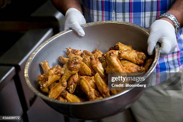 Chicken wings are removed from the fryer at the Anchor Bar in this arranged photograph in Buffalo, New York, U.S., on Wednesday, Sept. 24, 2014. The...