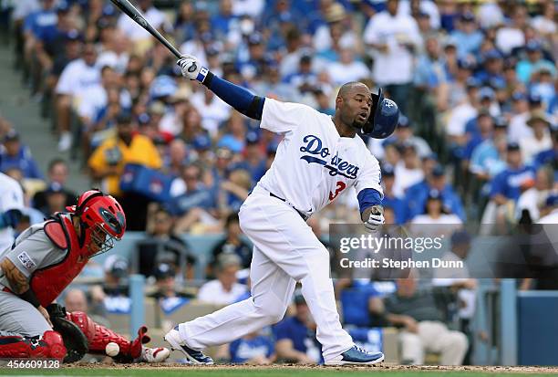 Carl Crawford of the Los Angeles Dodgers loses his helmet as he strikes out swinging for the first out in the bottom outfield the second inning...