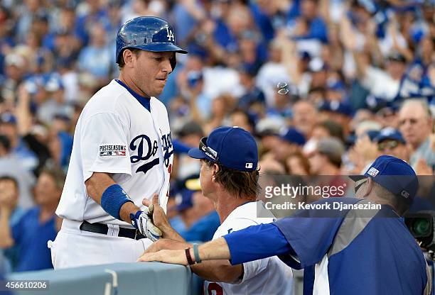 Ellis of the Los Angeles Dodgers is congratulated by manager Don Mattingly after his two-run homerun in the fifth inning during Game One of the...