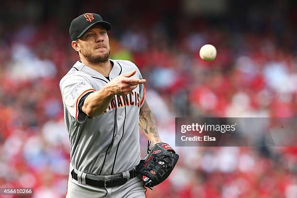 Jake Peavy of the San Francisco Giants tosses the ball during Game One of the National League Division Series against the Washington Nationals at...